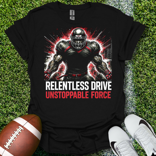 Black t-shirt with football player graphic and text 'Relentless Drive Unstoppable Force' on grass with a football and shoes.