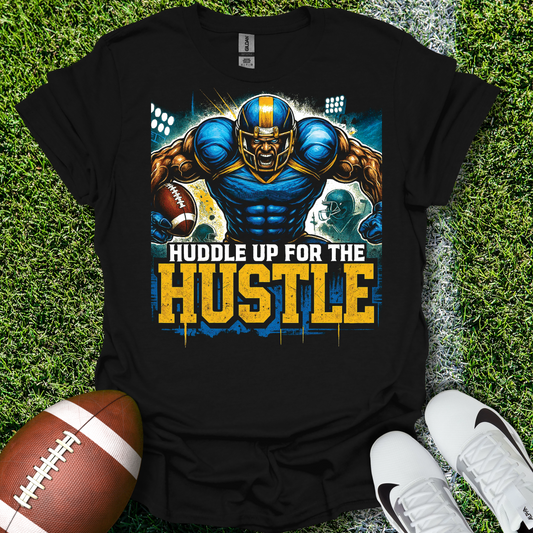 Black t-shirt with a football-themed graphic and text 'Huddle Up for the Hustle' on grass with a football and shoes.