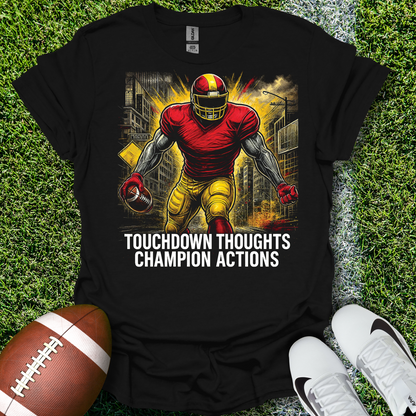 Black t-shirt with football player graphic and text on grass with football and shoes