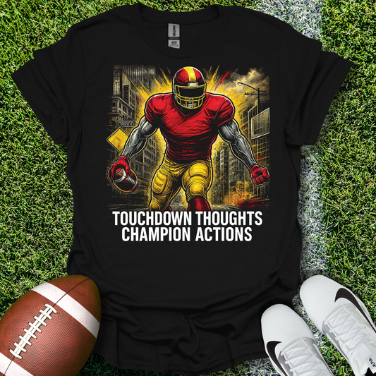Black t-shirt with football player graphic and text on grass with football and shoes